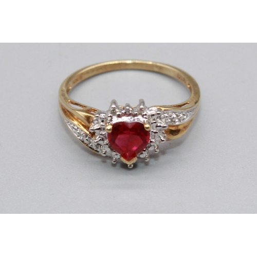 79 - 10ct yellow gold ring set with ruby heart cut stone surrounded by a halo of diamonds, on diamond twi... 