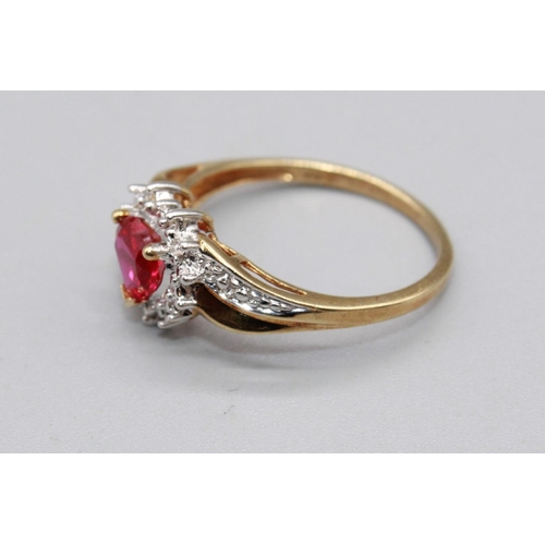 79 - 10ct yellow gold ring set with ruby heart cut stone surrounded by a halo of diamonds, on diamond twi... 