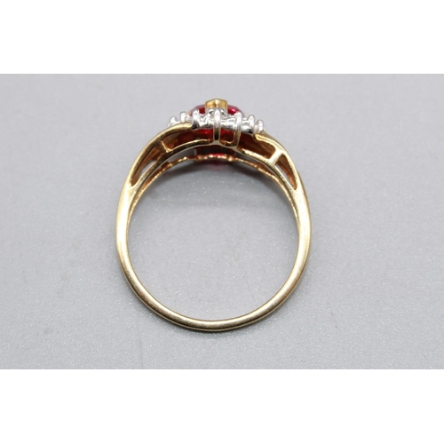 79 - 10ct yellow gold ring set with ruby heart cut stone surrounded by a halo of diamonds, on diamond twi... 