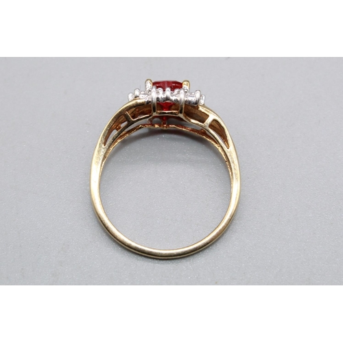 79 - 10ct yellow gold ring set with ruby heart cut stone surrounded by a halo of diamonds, on diamond twi... 