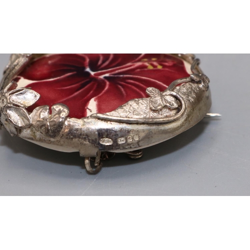 571A - Moorcroft Pottery: ‘Hibiscus’ pattern ceramic roundel set in a silver foliate mount, mount stamped M... 