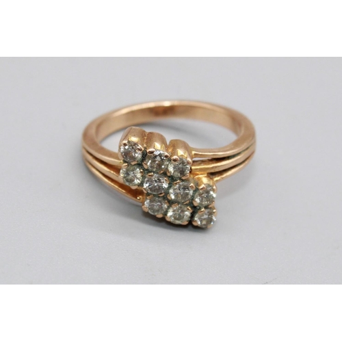 100 - Yellow metal ring set with three rows of brilliant cut diamonds, on cut-out shoulders, unmarked, siz... 