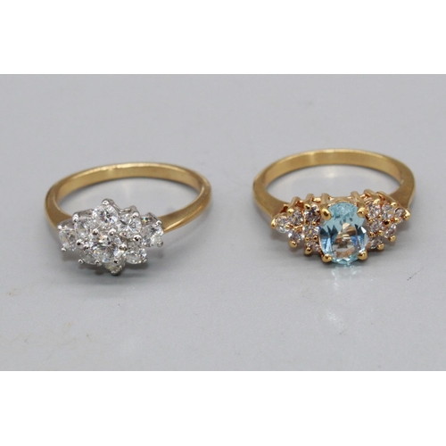 102 - Unmarked yellow metal ring set with pale blue central stone, flanked on either side by five white st... 