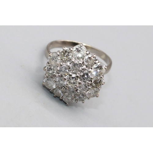 36 - White metal diamond cluster ring, set with nineteen brilliant cut diamonds, stamp worn but possibly ... 