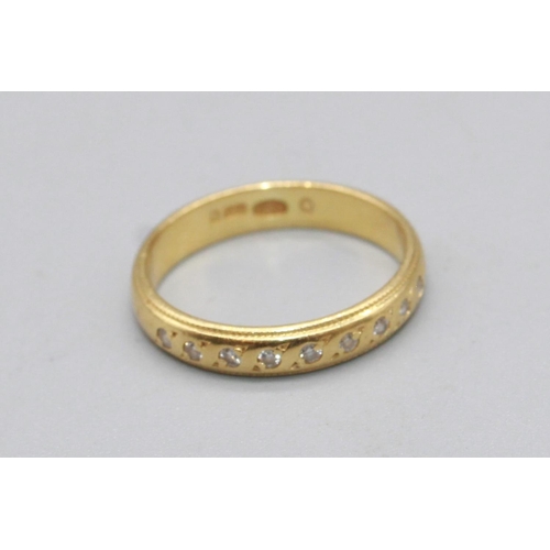 51 - 18ct yellow gold band ring, half inset with brilliant cut diamonds, stamped 750, size I1/2, 2.6g