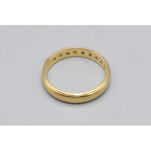 51 - 18ct yellow gold band ring, half inset with brilliant cut diamonds, stamped 750, size I1/2, 2.6g