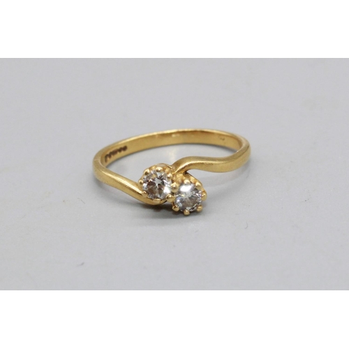 59 - 18ct yellow gold diamond cross over ring, set with two brilliant cut diamonds, stamped 750, size L1/... 