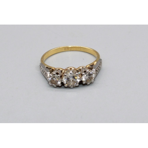 65 - 18ct yellow gold three stone diamond ring, on diamond set shoulders, stamped 18, size J, 3.0g