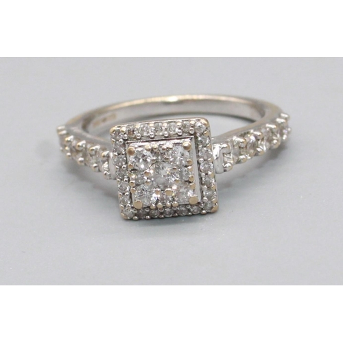 93 - 18ct white gold square faced ring set with brilliant cut diamonds, on diamond set shoulders, stamped... 