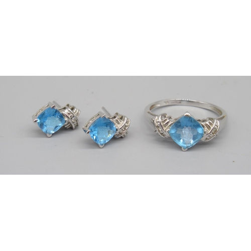 705 - 9ct white gold single stone blue stone ring, stamped 375, and a pair of matching earrings stamped 9k... 