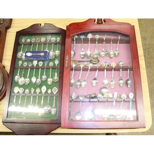 172 - Collection of EPNS souvenir spoons in two glazed cabinets and C20th mahogany aneroid wheel barometer... 