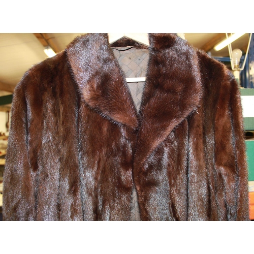 354 - Two long mink coats, one long dark brown mink fur and one black overcoat with full mink lining and a... 