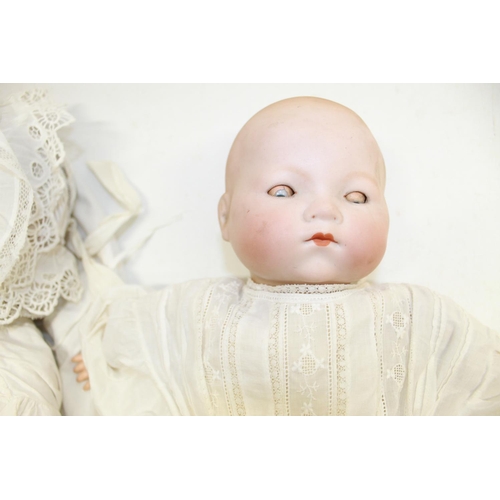 399 - Two early 20th century bisque head baby dolls: crying doll marked Simon and Halbig 126, white gown a... 