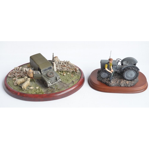 185 - Two well presented farming related dioramas to include resin/ceramic grey tractor with resting drive... 