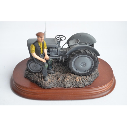 185 - Two well presented farming related dioramas to include resin/ceramic grey tractor with resting drive... 