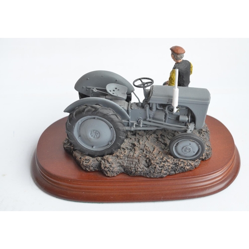 185 - Two well presented farming related dioramas to include resin/ceramic grey tractor with resting drive... 