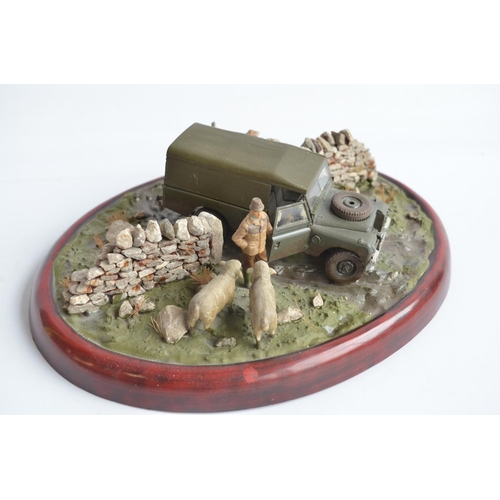 185 - Two well presented farming related dioramas to include resin/ceramic grey tractor with resting drive... 