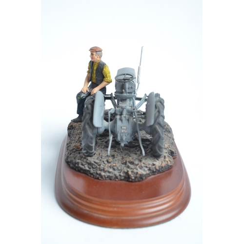 185 - Two well presented farming related dioramas to include resin/ceramic grey tractor with resting drive... 