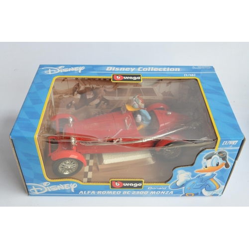 192 - Four 1/18 scale diecast Disney themed model cars from Burago to include Mickey Mouse Lancia Aurelia ... 