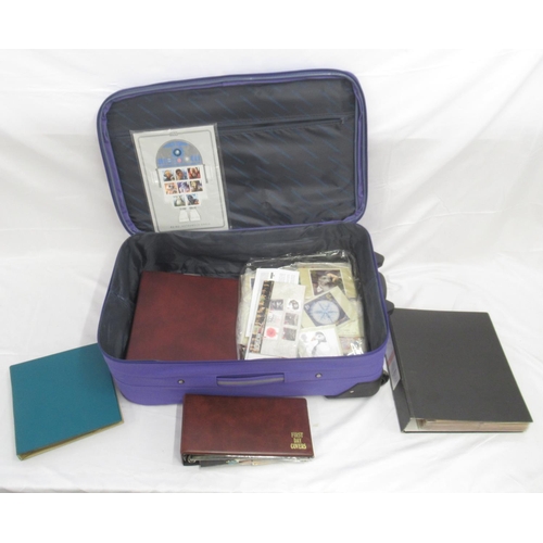 843 - Purple suitcase cont. an assorted collection of postcards, stamps covers, etc. both loose and in fol... 