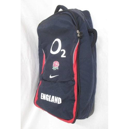 951 - Collection of assorted Rugby related clothing to inc. a England 02 suitcase, rucksack and travel bag... 