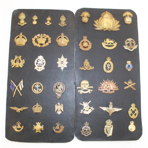 Eight cards containing a selection of metal military badges incl. Royal ...