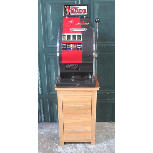 273 - Money Matador One Armed Bandit Slot Machine, H82cm W48.5cm D45cm , in working order, on a oak 2 draw... 