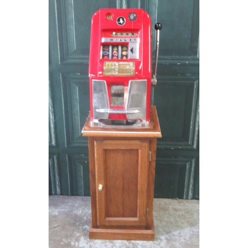 274 - Mills Hi-Top One Armed Bandit Slot Machine, H64.5cm W44.5cm D40cm , on a single door cabinet,