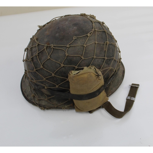 1128 - American WW2 M1 Helmet, complete with liner, camouflage netting, and a wound dressing.