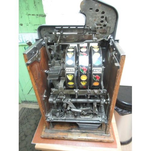 271 - 1930s Roman Head One Armed Bandit Slot Machine, H66.5cm W40.4cm D37.5cm, in working order, on a oak ... 