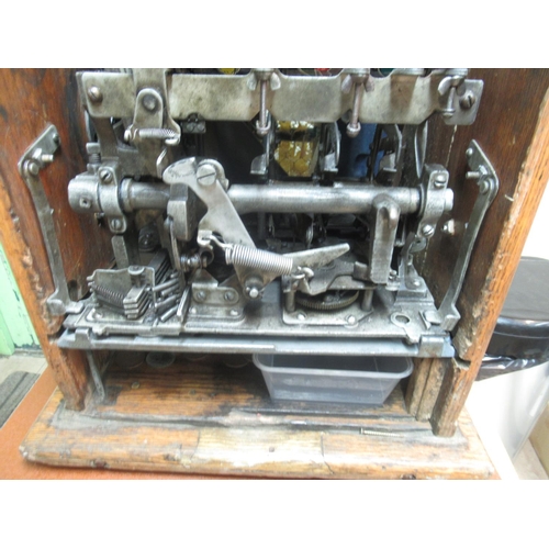271 - 1930s Roman Head One Armed Bandit Slot Machine, H66.5cm W40.4cm D37.5cm, in working order, on a oak ... 