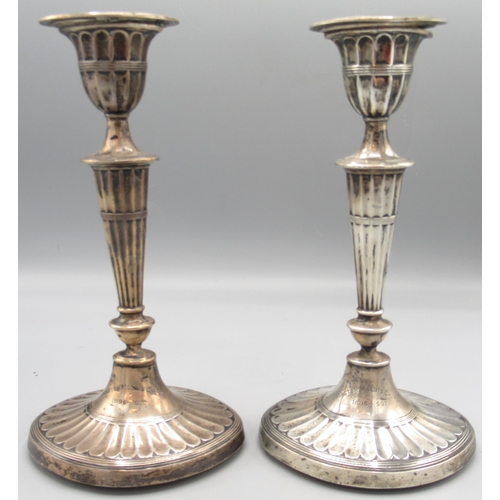 1263 - Pair of Edwardian silver neoclassical style candlesticks with reeded bases, urn sconces on ovoid col... 