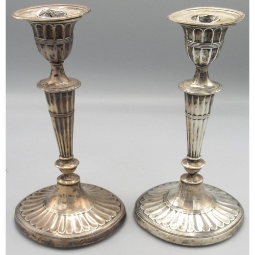 1263 - Pair of Edwardian silver neoclassical style candlesticks with reeded bases, urn sconces on ovoid col... 