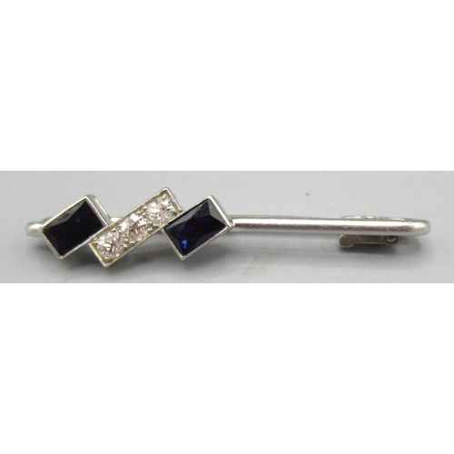 1023 - White metal brooch set with sapphires and diamonds, unmarked, 3.7g