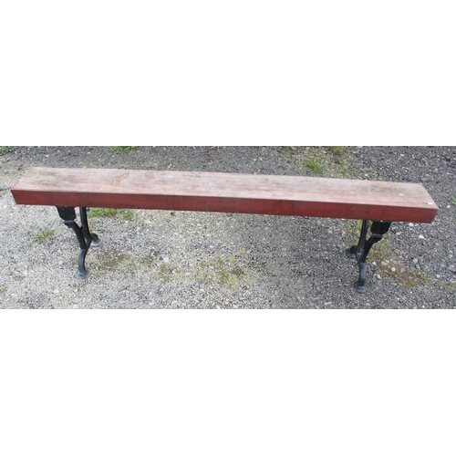 1589 - Large garden bench/form with cast iron legs and heavy wooden seat. 199cmx50cm