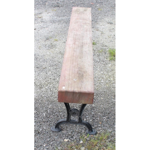 1589 - Large garden bench/form with cast iron legs and heavy wooden seat. 199cmx50cm