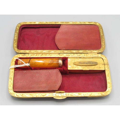 1303 - Leather and gilt metal cigar case with fitted interior, and a cheroot holder with yellow metal mount... 