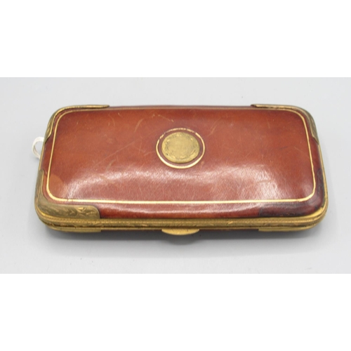 1303 - Leather and gilt metal cigar case with fitted interior, and a cheroot holder with yellow metal mount... 