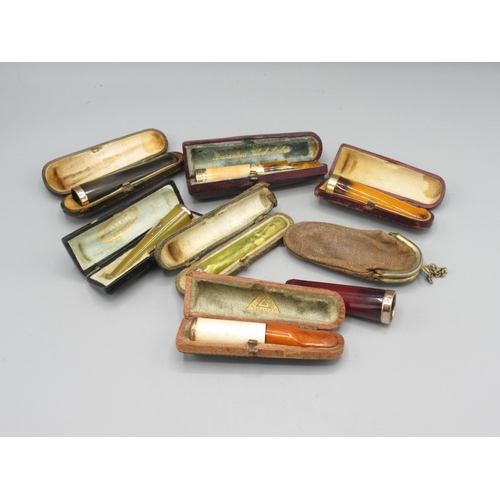 1304 - Collection of gold and yellow metal mounted cigar and cheroot holders, incl. 18ct gold and amber cig... 