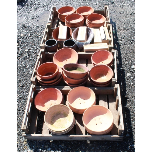 1597 - (Large quantity). Four crates of terracotta plant pot holders of various sizes and ages