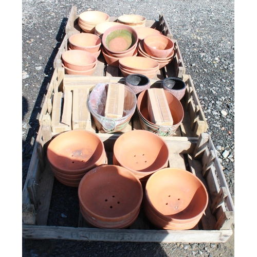 1597 - (Large quantity). Four crates of terracotta plant pot holders of various sizes and ages