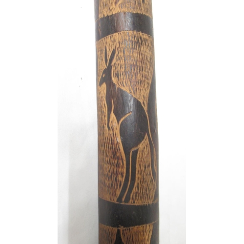 20 - Carved didgeridoo with images of Kangaroo, Snakes, etc. carved wood 4-string instrument lacking 2 st... 