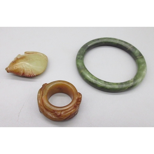 120 - Chinese jade archers thumb ring carved with two dragons, a carved jade fish pendant and a polished g... 