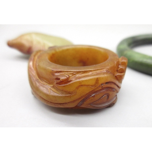 120 - Chinese jade archers thumb ring carved with two dragons, a carved jade fish pendant and a polished g... 