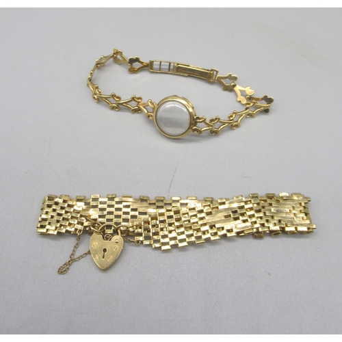 1643 - 9ct yellow gold 9 bar gate bracelet, with heart padlock clasp, and a 9ct yellow gold ornate watch br... 