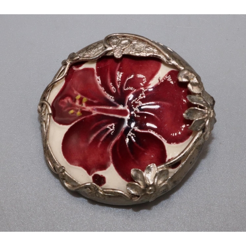 1369 - Moorcroft Pottery: ‘Hibiscus’ pattern ceramic roundel set in a silver foliate mount, mount stamped M... 