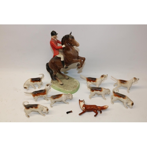 1145 - Beswick fox hunting group comprising Huntsman on rearing horse no. 868, H24cm; eight hounds and a fo... 