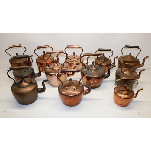 1163 - Twelve Victorian copper kettles all with acorn finials, H28.5cm (2)