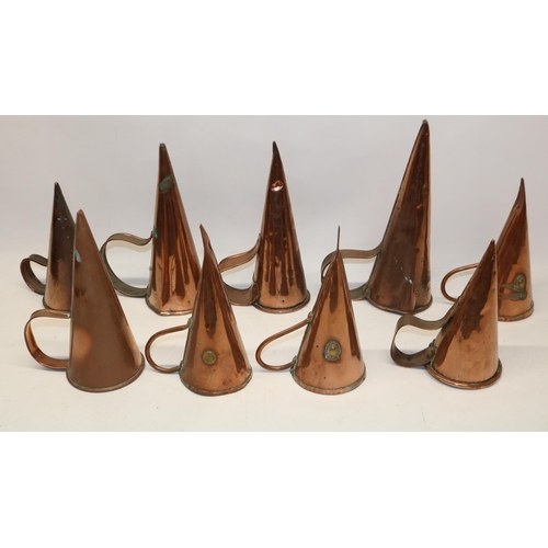 1170 - Nine 19th century copper ale warmers with rivetted strap handles, 28cm