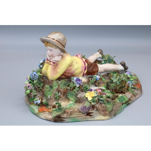 1308 - Crown Staffordshire figure group, modelled by T Bayley, signed, modelled as a reclining boy scout on... 